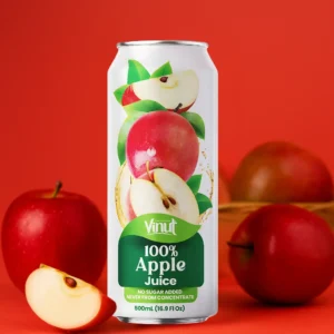 A can of Vinut 100% Apple Juice is displayed in front of whole and sliced red apples, set against a solid red background.