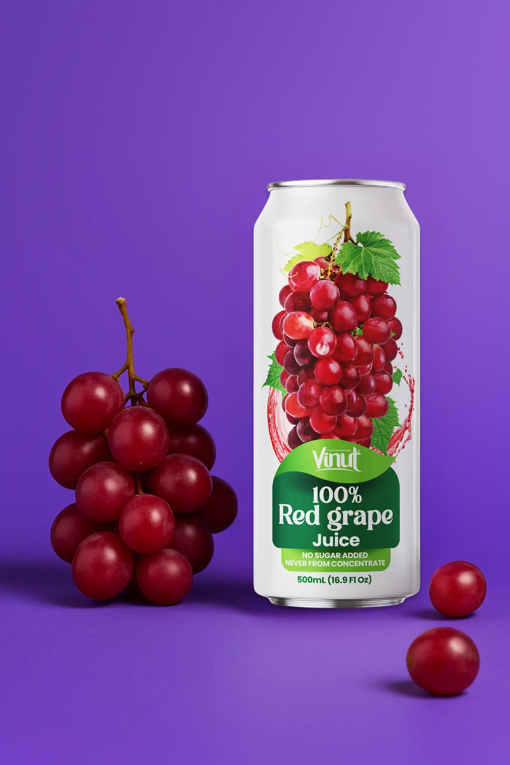 Red-Grape-VINUT-100-Real-Fruit-Juice-No-Sugar-Added-Tropical-Organic-Non-GMO-Drink-Vinut-Now-38344604877049 A can of Vinut 100% red grape juice is placed next to a bunch of red grapes and two loose grapes on a purple background.