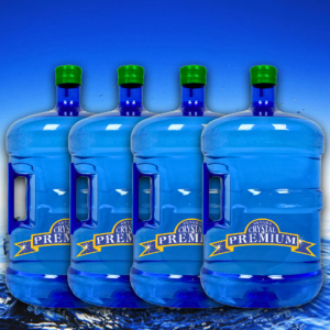 Four large blue water jugs with green caps labeled "Crystal Premium" are aligned in front of a water surface background, perfect for your Spring hydration needs or as part of a convenient 6 Bottle Plan.