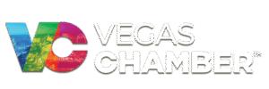 Logo with multicolored “VC” featuring Vegas landmarks, next to the words “Vegas Chamber” in bold white capital letters on a light background.